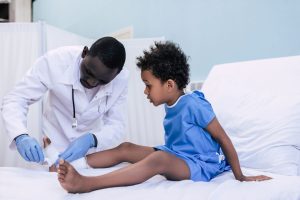 doctor treating young boy
