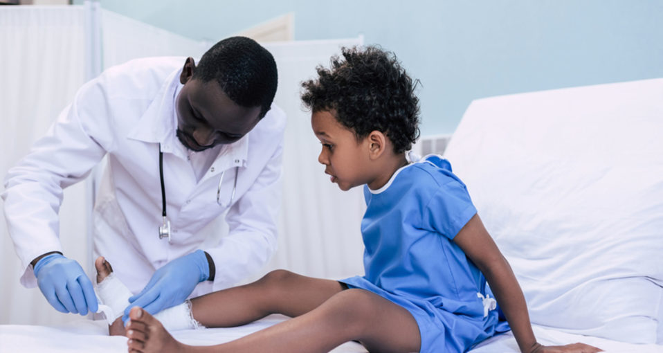 doctor treating young boy