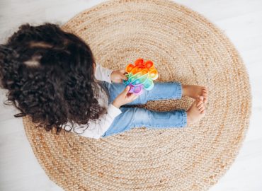 African,American,Girl,On,The,Floor,At,Home,Playing,With